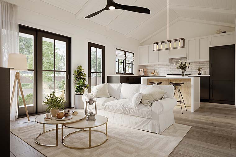 Interior of Cottage House Plan 42920 featuring vaulted ceiling, cozy fireplace, and open living area connected to kitchen