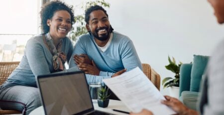 Homeowner compiling construction loan documents including budget, blueprints, and builder contract