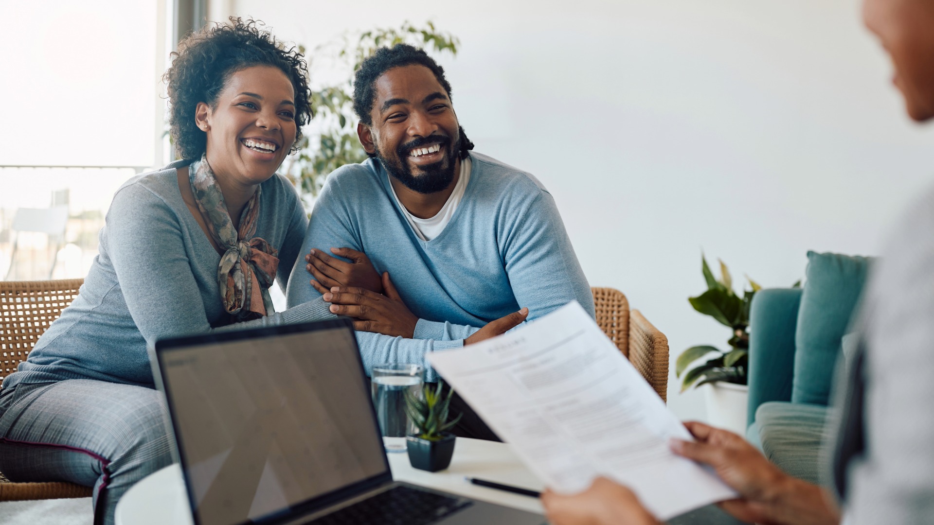 Homeowner compiling construction loan documents including budget, blueprints, and builder contract