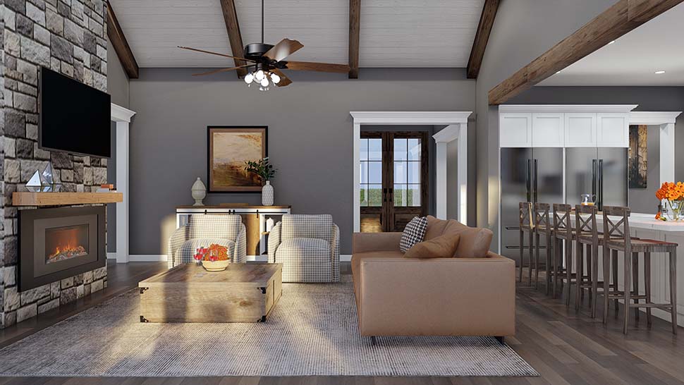 Great room interior of Farmhouse Plan 82762 with vaulted ceilings and fireplace