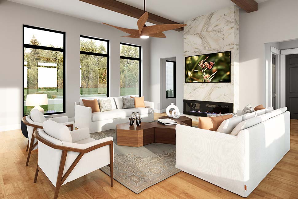 Great room interior of Modern Ranch house plan 82925 with volume ceiling, fireplace, and open layout